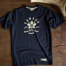 Load image into Gallery viewer, Navy blue t-shirt with white graphic design on a wooden surface.