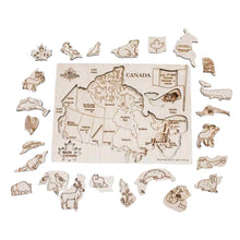 Load image into Gallery viewer, Wooden puzzle of Canada with native animals. Placed outside of the board animals are waiting to be placed.