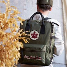 Load image into Gallery viewer, View of backpack being worn on a persons back.
