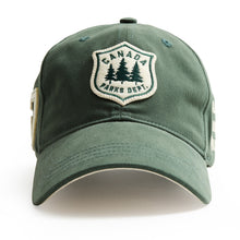 Load image into Gallery viewer, A green cotton baseball cap featuring an embroidered shield patch on the front with the text 'CANADA PARKS DEPT.' and pine trees, shown on a white background.
