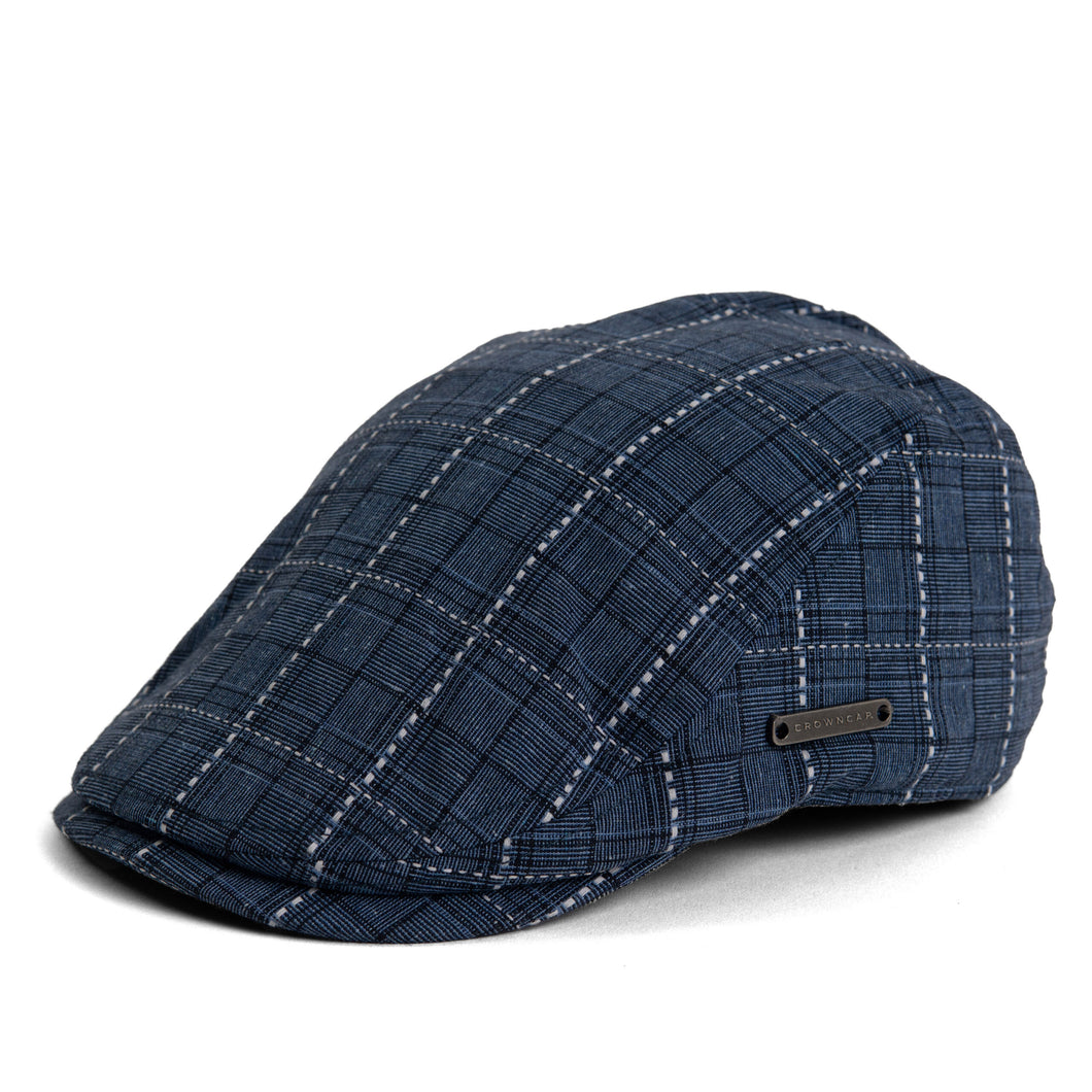 Blue linen Ivy cap with a traditional flat-top design and duckbill brim with comfort inert. Side view of cap, made in Canada.