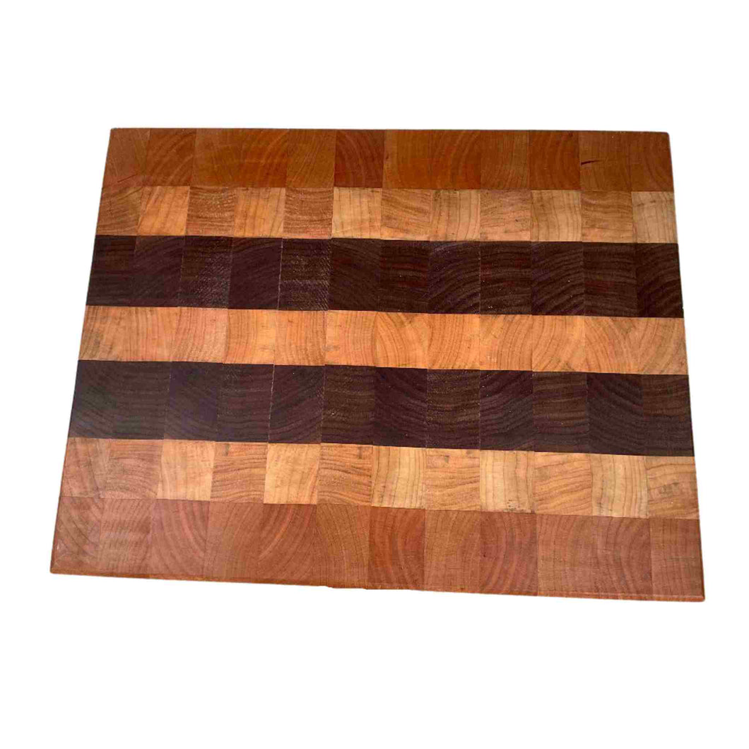 Handmade cutting board using cherry, maple and walnut wood.