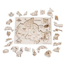 Load image into Gallery viewer, Wooden puzzle of Canada with native animals. Placed outside of the board animals are waiting to be placed.
