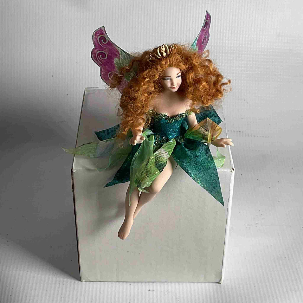 Sitting fairy with a beautiful smile, handmade porcelain.