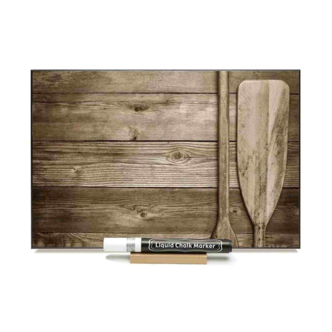 Photo chalkboard of paddles against barn board.