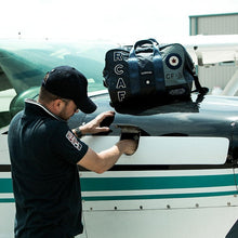 Load image into Gallery viewer, Man getting ready for air flight with carry bag.
