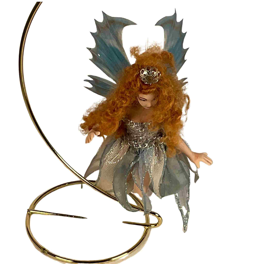 Shimmering turquoise flying fairy handmade with porcelain.