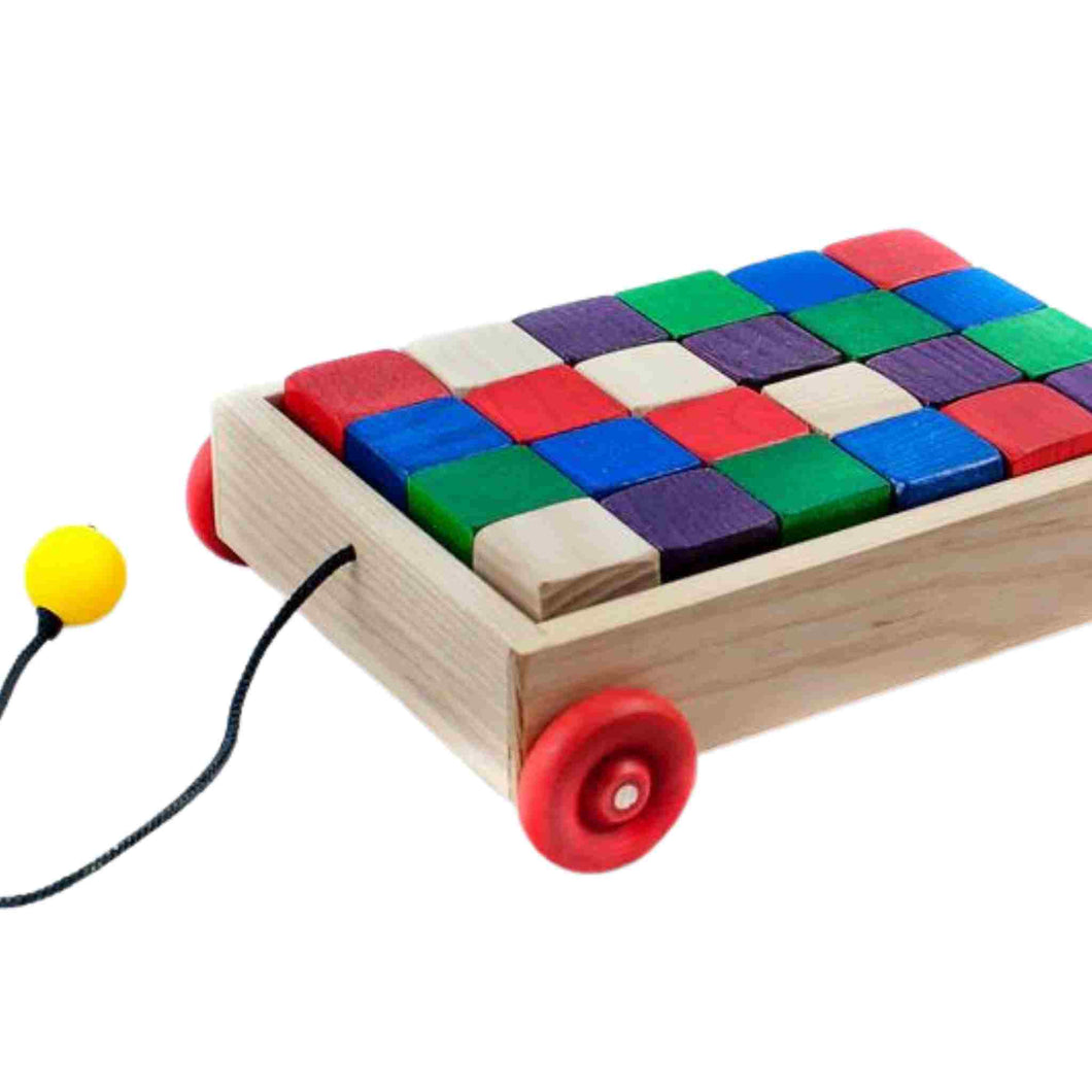 Little children's pull wagon with colourful blocks.