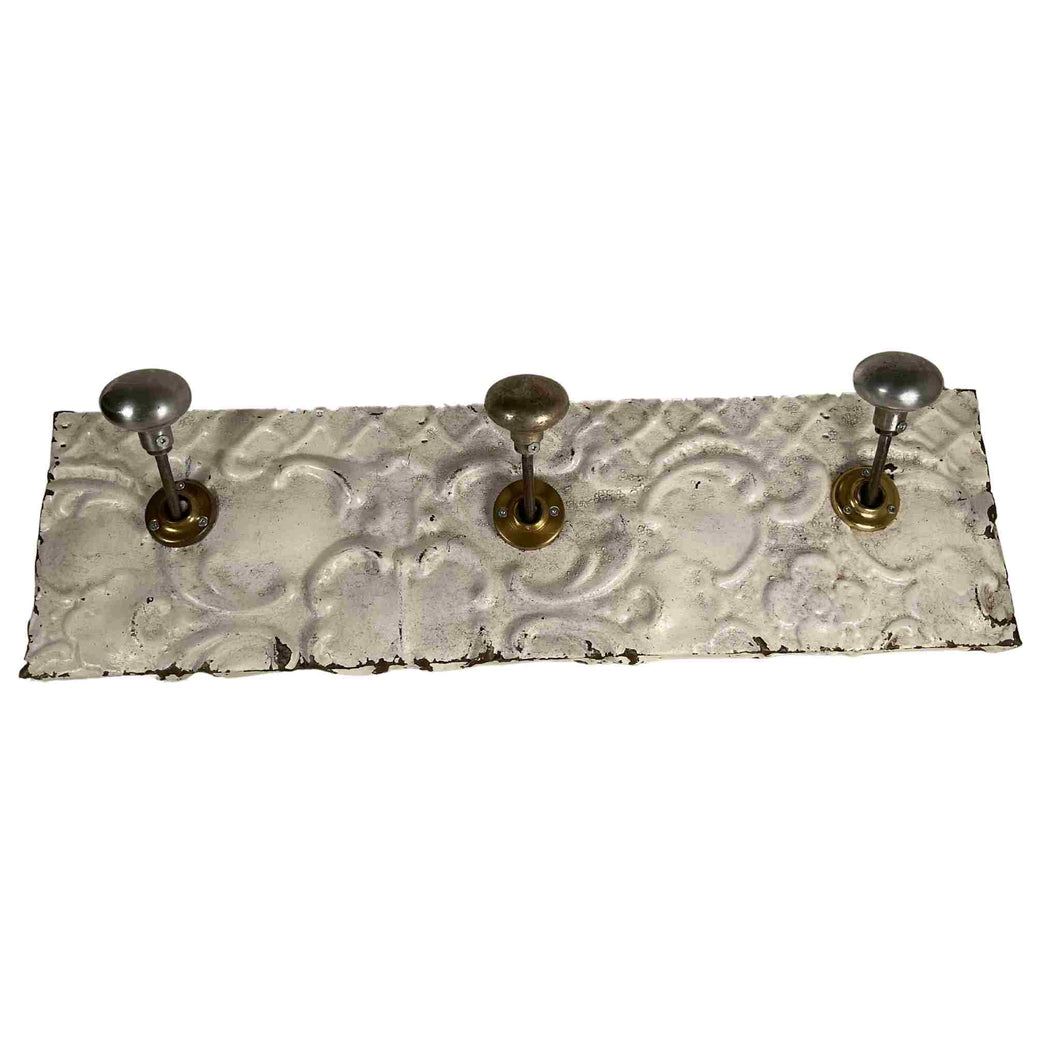 Coat rack made from tin and old door knobs.