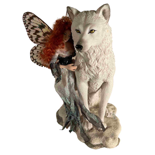 Handmade porcelain fairy standing with a white wolf. 